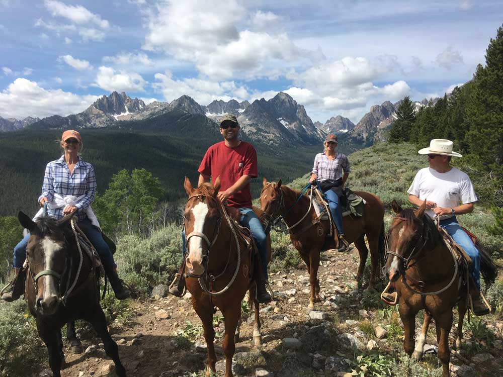 people riding horses in the mountains of Sawtooth Valley, Idaho